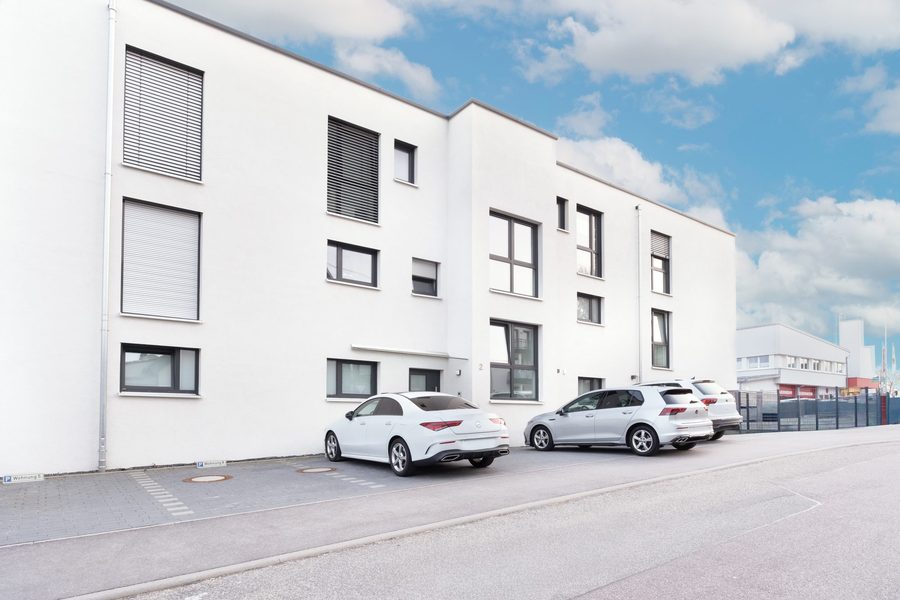 Weißer Neubau unter blauem Himmel